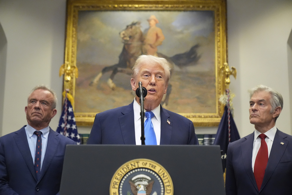 President Donald Trump speaks in the Roosevelt Room of the White House, Monday, Sept. 22, 2025, in Washington, as Health and Human Services Secretary Robert F. Kennedy Jr., left, and Centers for Medicare & Medicaid Services administrator Dr. Mehmet Oz listen. 