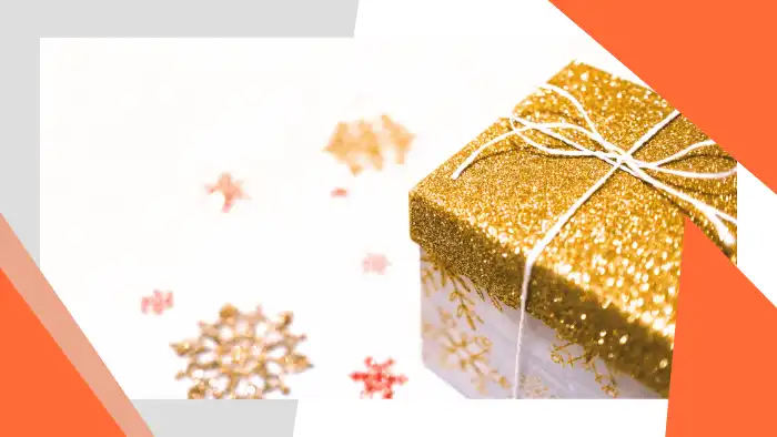 Wrapped gift surrounded by holiday decorations