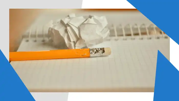 Pencil next to crumpled notebook paper