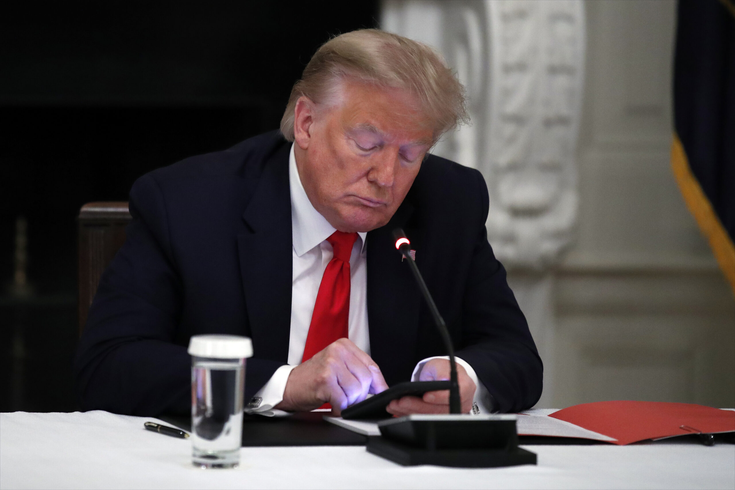Donald Trump using his cell phone