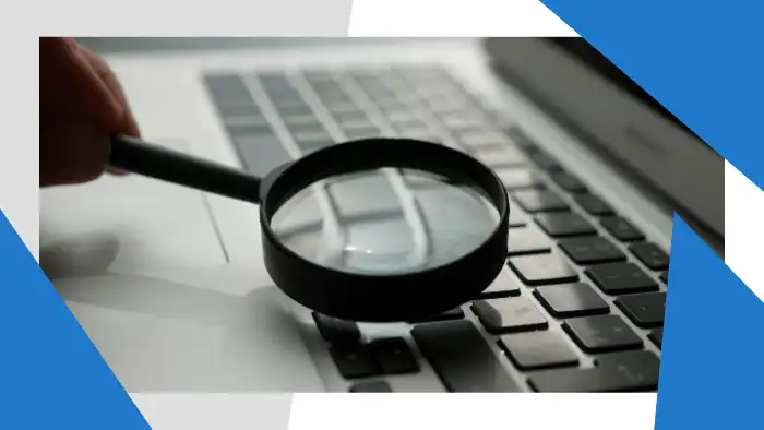 Magnifying glass over a laptop keyboard