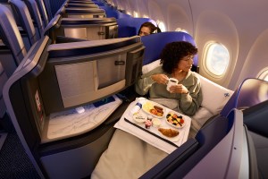 Woman eating in-flight meal on United Airlines flight