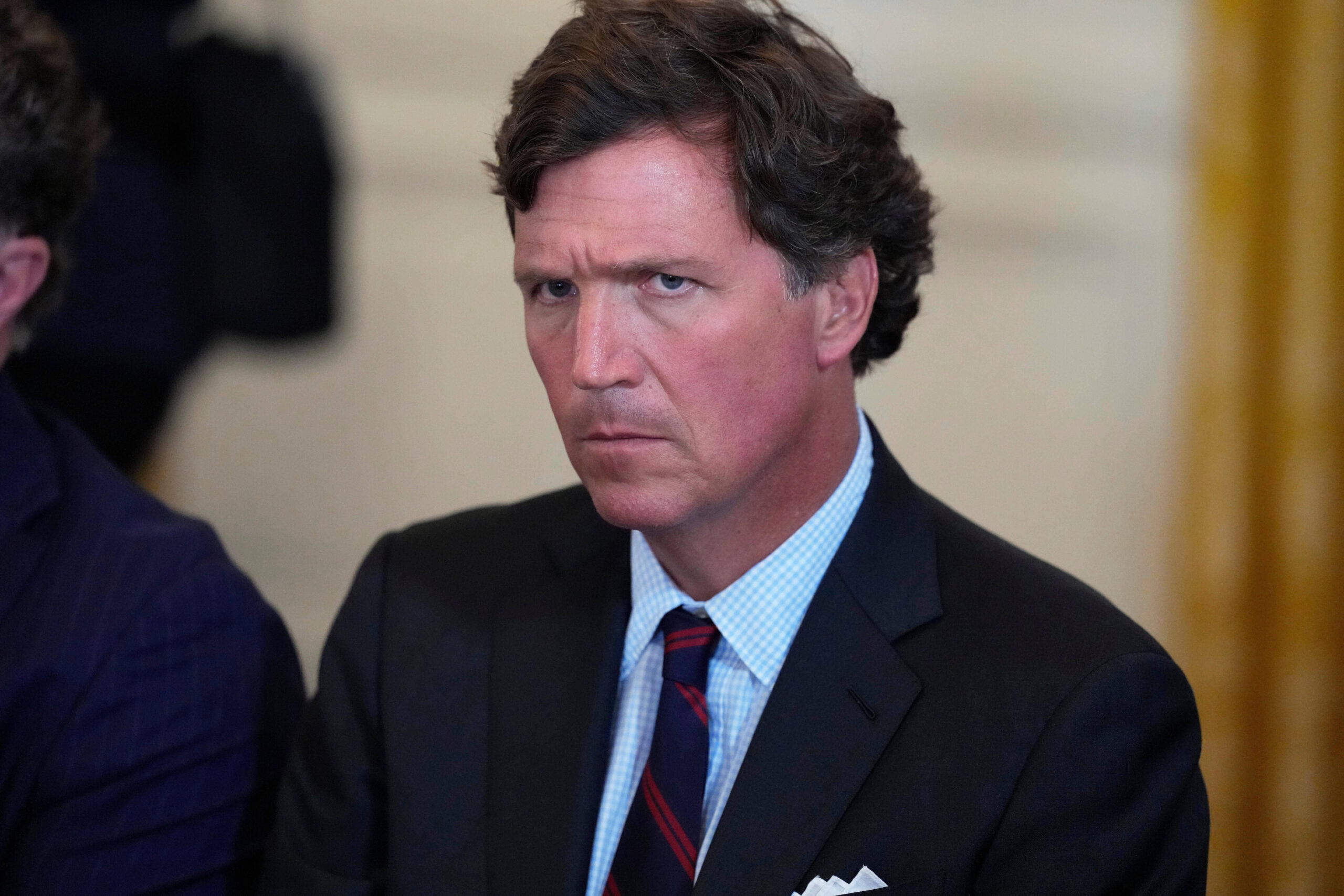 FILE - Tucker Carlson attends a meeting with President Donald Trump and oil executives in the East Room of the White House, Friday, Jan. 9, 2026, in Washington.